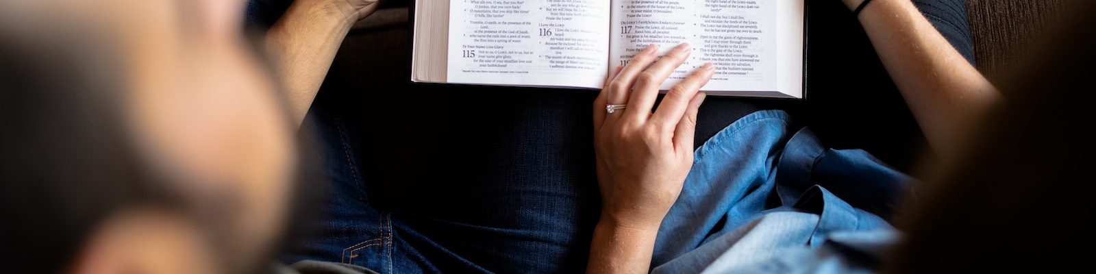 couple reading book on couch