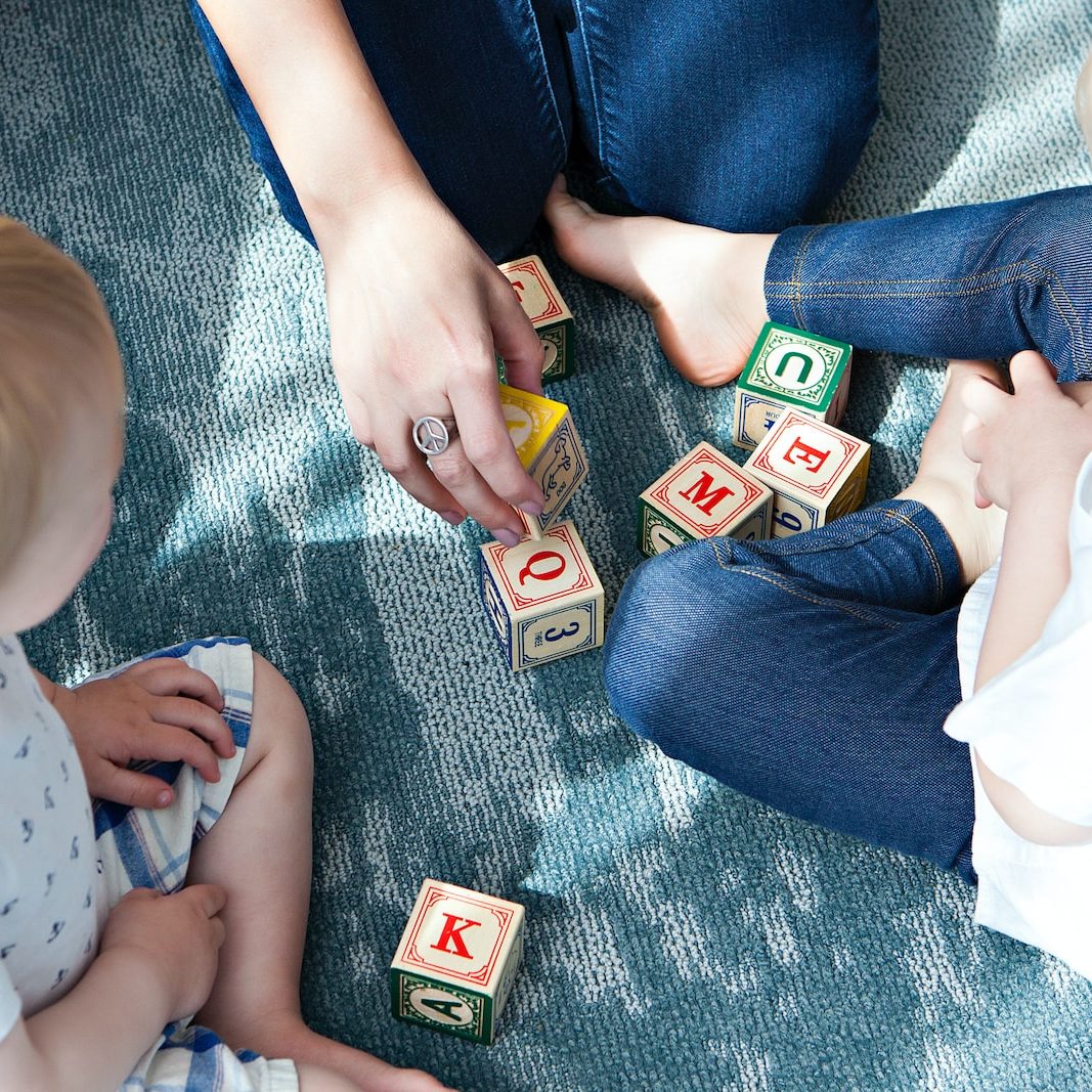 Photo by Marisa Howenstine two toddler playing letter cubes